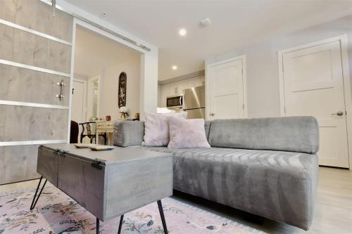 a living room with a couch and a table at Downtown DC Awaits with Parking Permit in Washington, D.C.