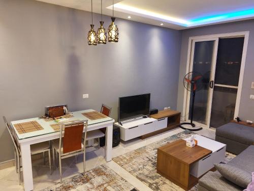 a living room with a desk and a tv at Private room in flat in Sharm El Sheikh