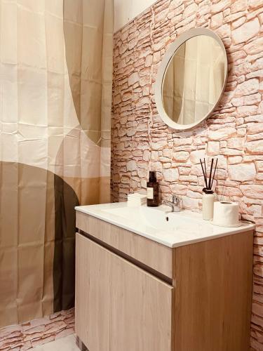 a bathroom with a sink and a mirror at Zambujeira Lounge in Zambujeira do Mar