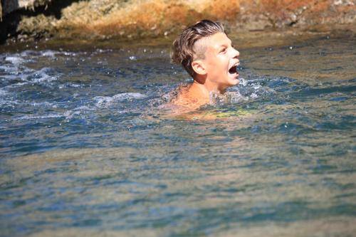 a young man in the water with his mouth open at Eremo Gioioso in Pontremoli