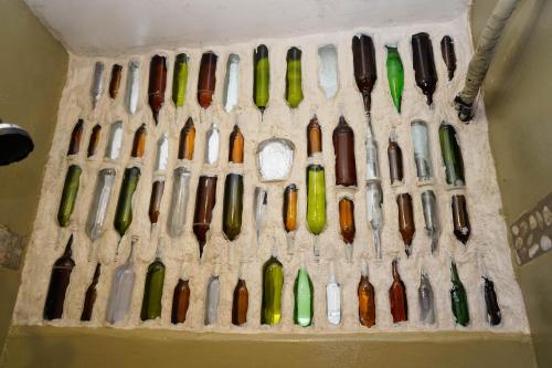 a display of wine bottles in a wall at Nuestra Casa in San Juan del Sur
