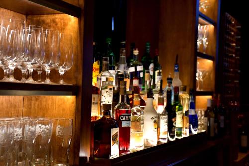 a bar with many bottles of alcohol and glasses at Tait House by Bower Boutique Hotels in Shediac