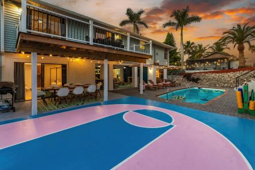 a villa with a swimming pool and a house at Casa Marco - Heated Pool, Game Room, Mini Golf in Marco Island