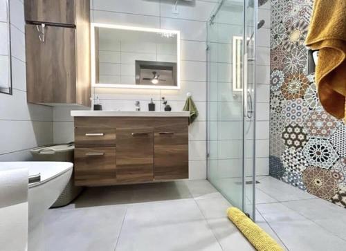 a bathroom with a sink and a shower at Gharb executive penthouse in Għarb