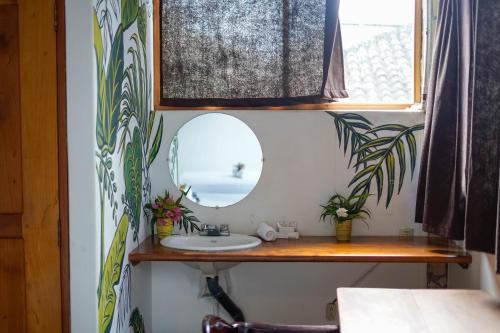 a bathroom with a sink and a mirror at Nuestra Casa in San Juan del Sur