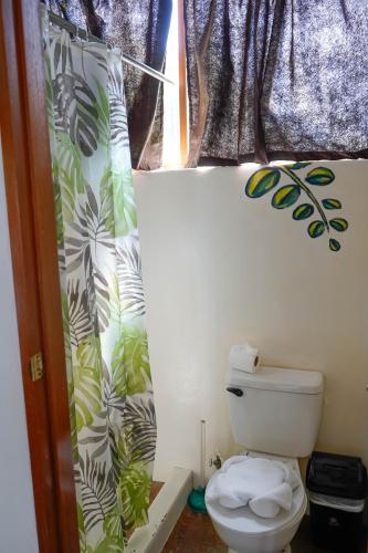 a bathroom with a toilet and a window at Nuestra Casa in San Juan del Sur