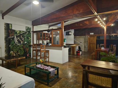 a living room with a table and a kitchen at Nuestra Casa in San Juan del Sur