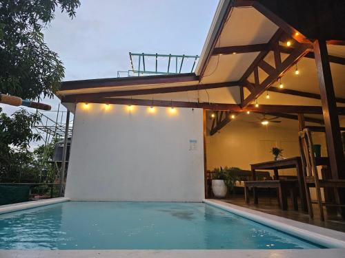 a house with a swimming pool with a building at Nuestra Casa in San Juan del Sur