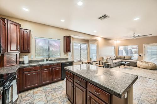 a kitchen with wooden cabinets and a living room at Whitton House - Hot Tub - Fire Pit - Pets OK in Avondale