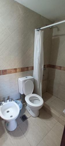 a bathroom with a toilet and a sink at Monoambiente super cómodo y cerca de todo in Mar de Ajó