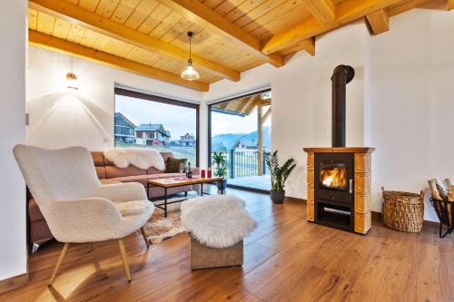 a living room with a fireplace and a couch at Chata FONGRUB in Mýto pod Ďumbierom
