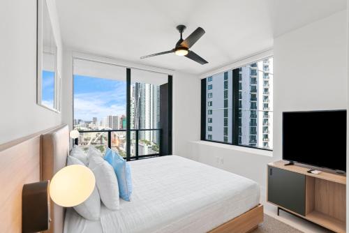 a bedroom with a bed and a flat screen tv at New 26th floor amazing view 2BR-2BA in Miami