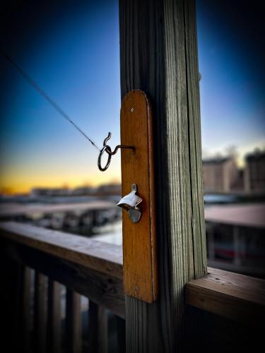 a pair of scissors attached to a wooden door at Daylight Cove Lakefront Condo, Pool, Hot Tub! in Lake Ozark
