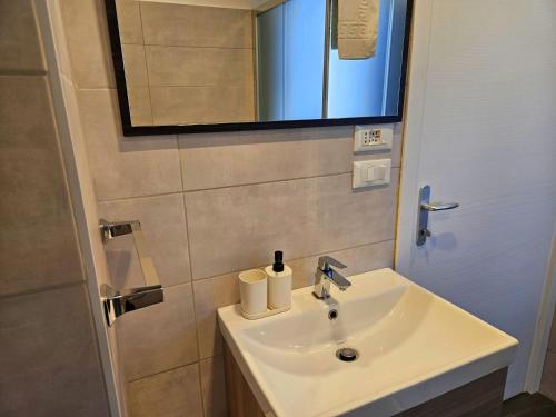 a bathroom with a white sink and a mirror at MiPA in Milazzo