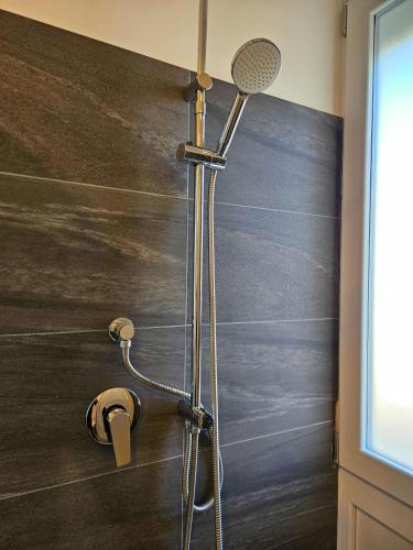 a shower with a shower head in a bathroom at MiPA in Milazzo