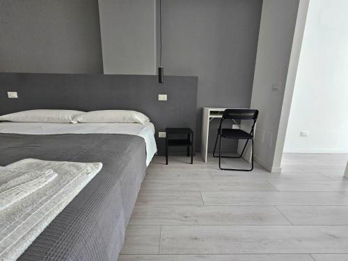 a bedroom with a bed and a desk and a chair at MiPA in Milazzo