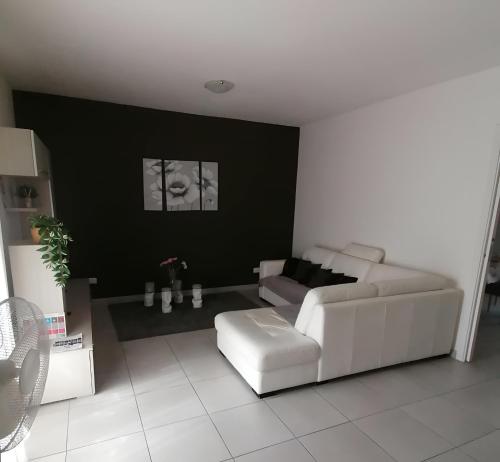 a living room with a white couch and a chair at Happydays - Equipped Suite - Appartamento Intero in Randazzo
