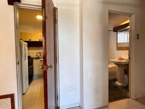 an open door to a kitchen with a sink at Casa Living Valparaiso in Valparaíso