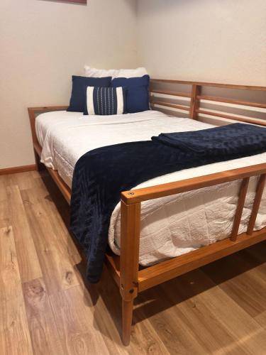a bed with a blue blanket on top of it at The Overlook At Cedar Point in Osage Beach