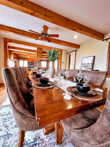 a dining room with a wooden table and chairs at The Overlook At Cedar Point in Osage Beach