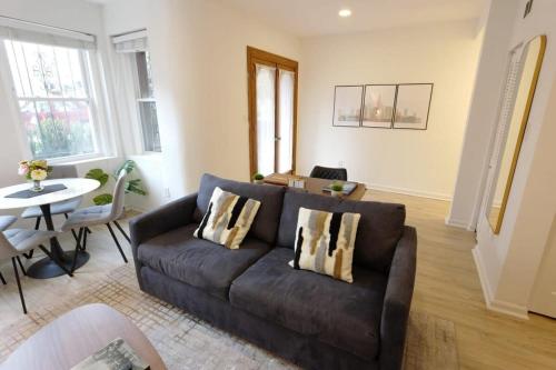 a living room with a brown couch and a table at The Grand Dame of Shaw-Between Shaw & Logan Circle in Washington, D.C.