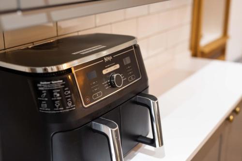a black toaster oven sitting in a kitchen at Southview Spa Windermere in Windermere
