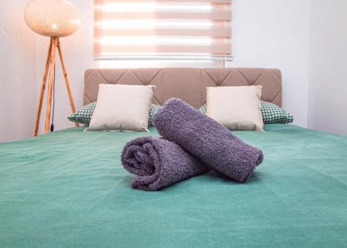 a stuffed animal is laying on a bed at Apartman Royal 4 in Doboj