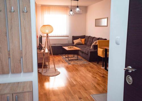 a living room with a couch and a table at Apartman Royal 4 in Doboj