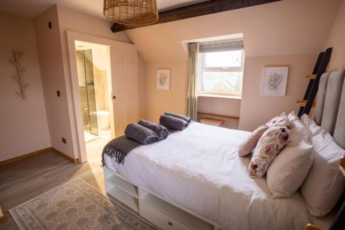a bedroom with a large white bed and a window at Southview Spa Windermere in Windermere