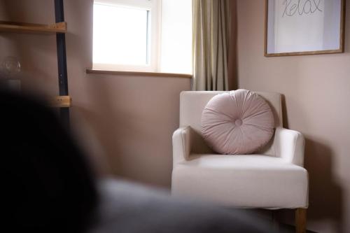 a white chair with a pillow in a room at Southview Spa Windermere in Windermere