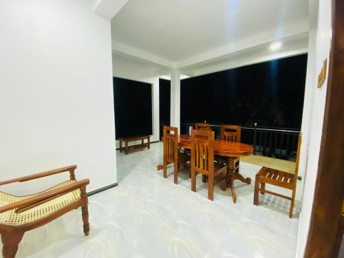 a dining room with a table and chairs on a balcony at Sun Palace Yala in Tissamaharama