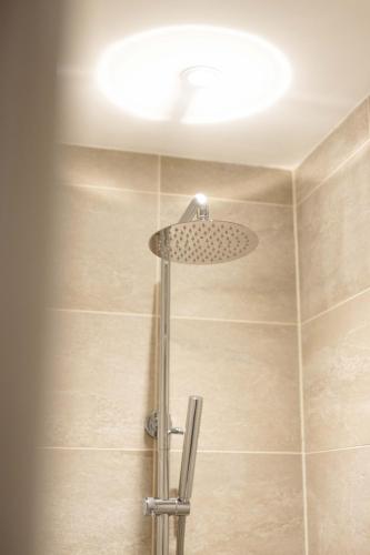 a shower with a shower head in a bathroom at Southview Spa Windermere in Windermere