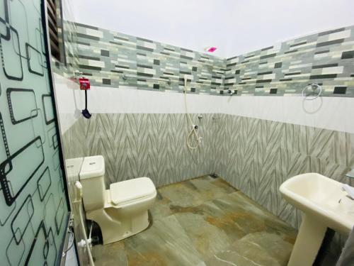 a bathroom with a toilet and a sink at Sun Palace Yala in Tissamaharama