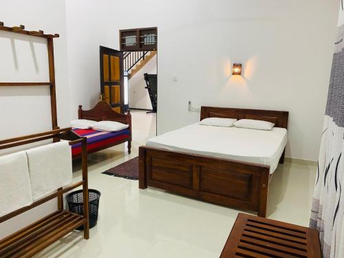 a bedroom with a bed and a chair in it at Sun Palace Yala in Tissamaharama
