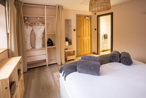 a bedroom with a white bed and a closet at Southview Spa Windermere in Windermere