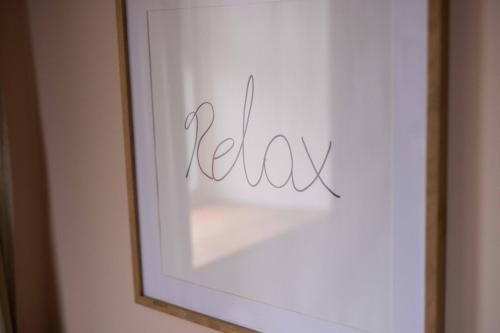 a picture of a sign that says relax at Southview Spa Windermere in Windermere