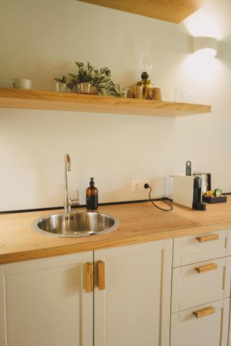 a kitchen counter with a sink in a kitchen at Ampeli Villas in Néa Artáki