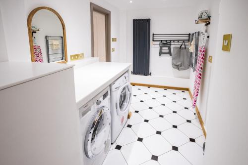 a white laundry room with a washer and dryer at Southview Spa Windermere in Windermere