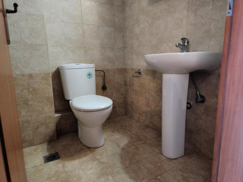 a bathroom with a toilet and a sink at Elevate Blue Apartment in Rethymno Town