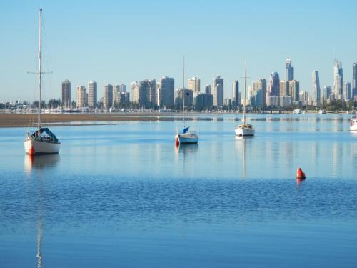 a group of boats in a large body of water with a city at Blue Waters Apartments in Gold Coast