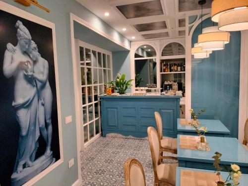 a dining room with a table and a bar at Villa Oteri Rooms & Bistrot in Bacoli