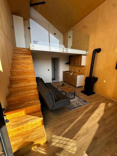 a living room with a staircase leading to a living room at Yaka Vadi Bungalov in Kızilbahçe