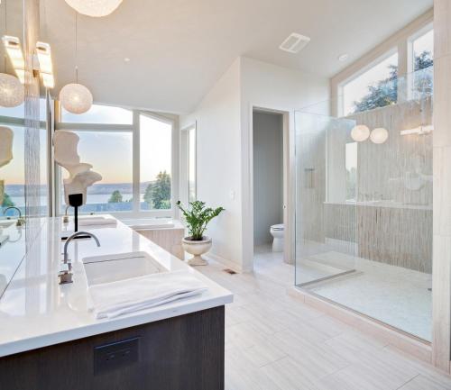 a bathroom with a glass shower and a sink at Luxe 220, Unit 2 - Front Street Suite in Wilmington