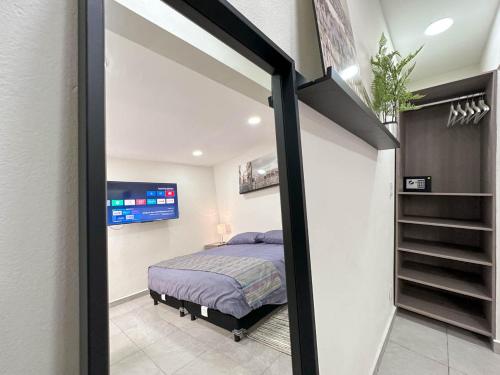 a bedroom with a bed and a sliding glass door at Casa Yautepec Condesa in Mexico City