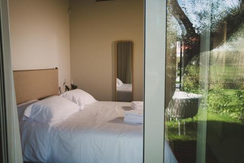 a bedroom with a bed and a glass door at Ampeli Villas in Néa Artáki