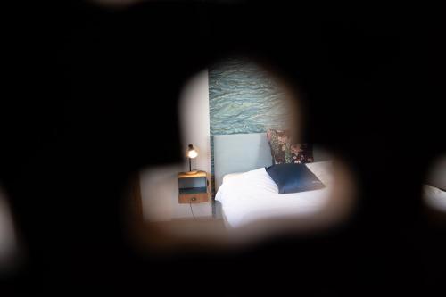 a bedroom with a bed with a blue pillow at La Ferme de la Cour in Herbeumont