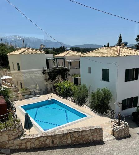 a swimming pool in front of a house at Villa Elpida Aspro in Koprána