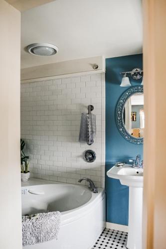 a bathroom with a white tub and a sink at Adair Country Inn & Restaurant in Bethlehem