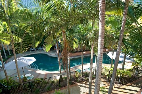 an overhead view of a swimming pool with palm trees at Blue Waters Apartments in Gold Coast