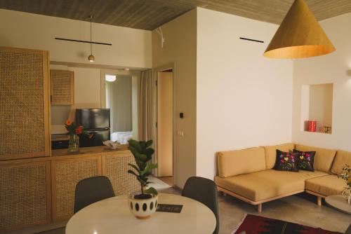 a living room with a couch and a table at Ampeli Villas in Néa Artáki